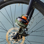 Bicycle wheel with a Fauna device attached against a blurred background